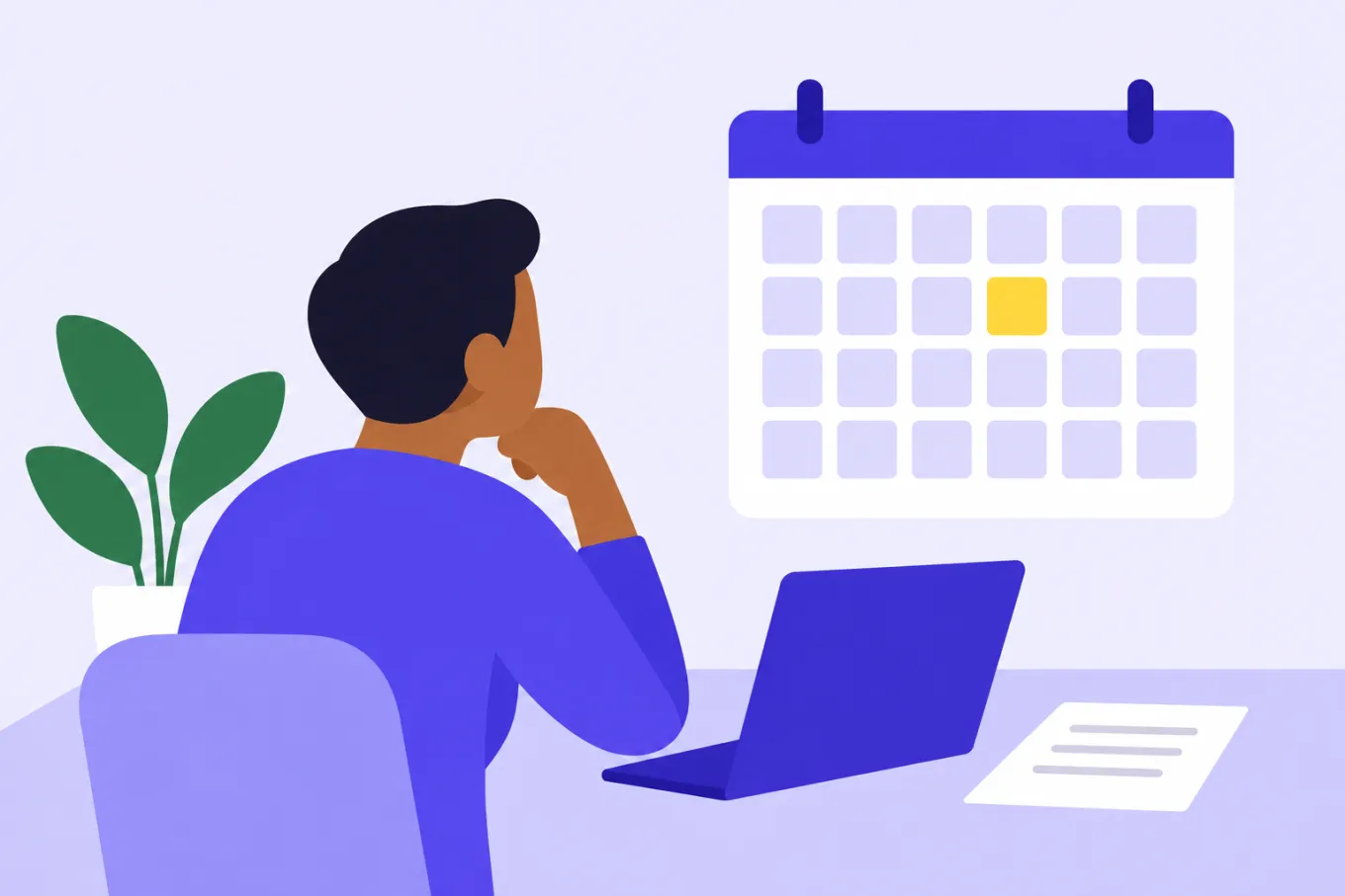 Un hombre sentado frente a su laptop mira un calendario de pared con un día marcado en amarillo.